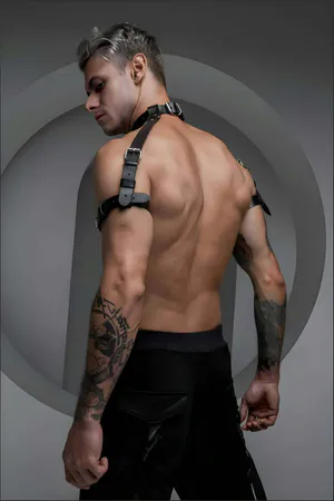 Black faux leather choker and shoulder harness set on male model