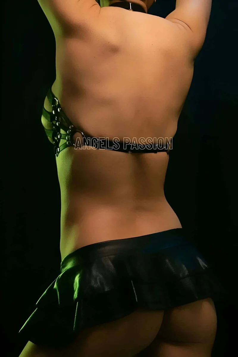Close-up of black strappy O-ring chest harness with metal clasps