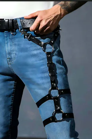 Black faux leather thigh harness with three O-rings and adjustable straps