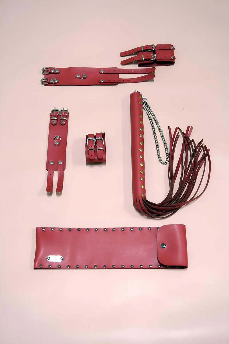 Red Faux Leather Restraint Set with Two Cuffs, Body Straps, and a Studded Whip