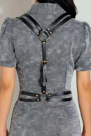 Black faux leather body harness with gold O-ring and adjustable buckle strap
