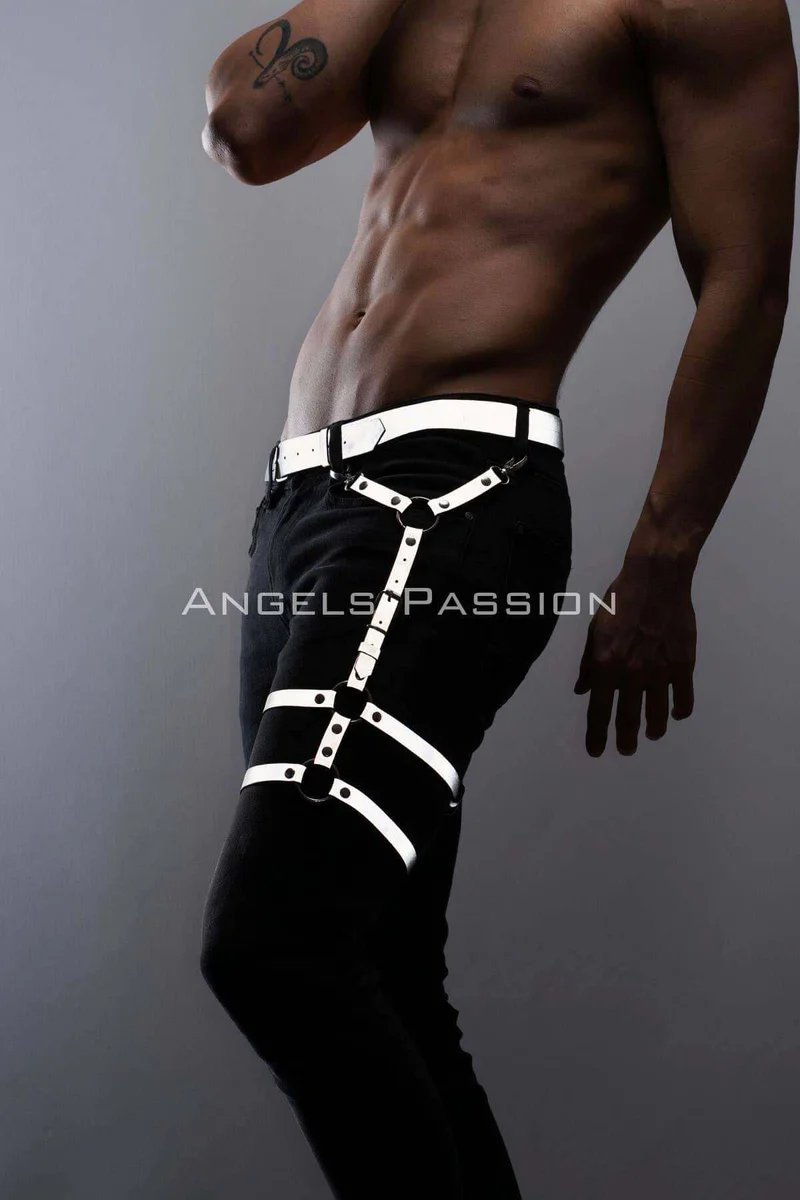 Model wearing black jeans with reflective leg harness accessory