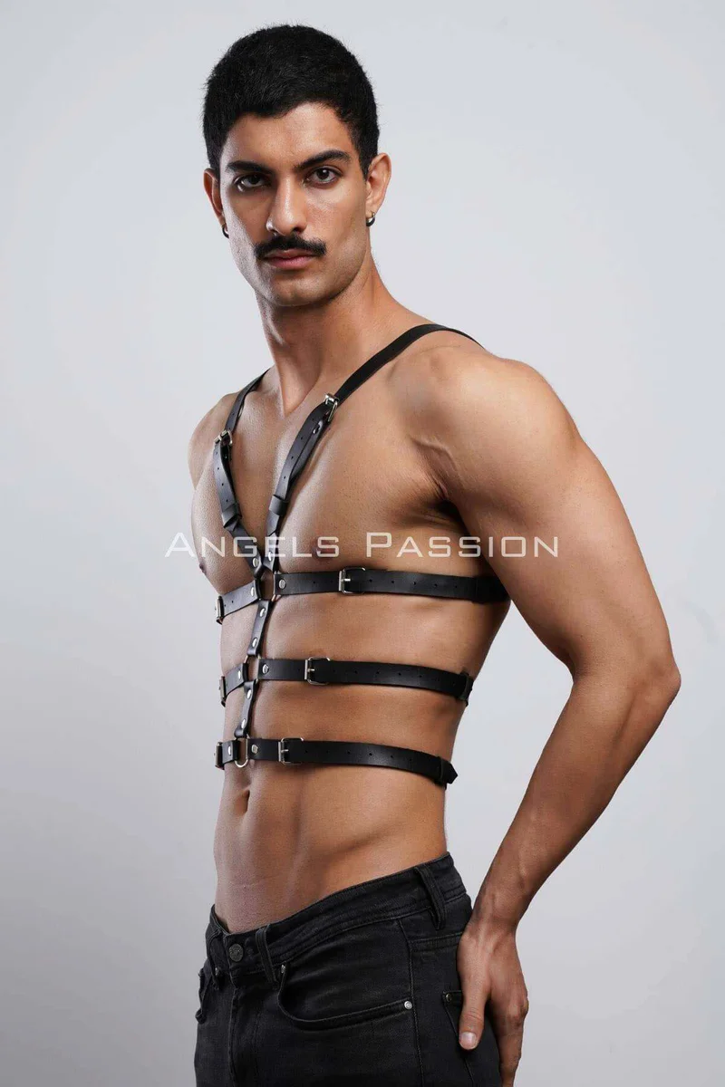 Adjustable black chest harness for men with multiple straps and buckles, worn as festival outfit detail