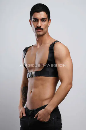 Black faux leather chest harness with silver buckle and adjustable straps on male model