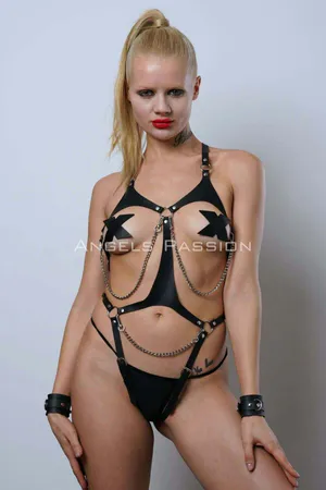 Black faux leather body harness with silver chain and O-ring detail worn by model