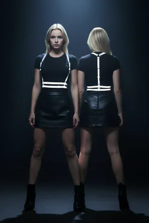 White reflective chest harness with faux leather straps on a model, front view