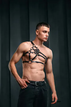 Structured black faux leather body harness with O-ring detail on model