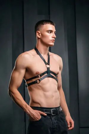 Black faux leather chest harness with O-ring detail and adjustable straps