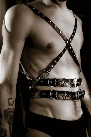 Black studded faux leather body harness with dual adjustable waist belts and X-chest straps