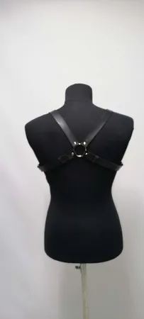 Black faux leather strappy chest harness with O-ring and buckle