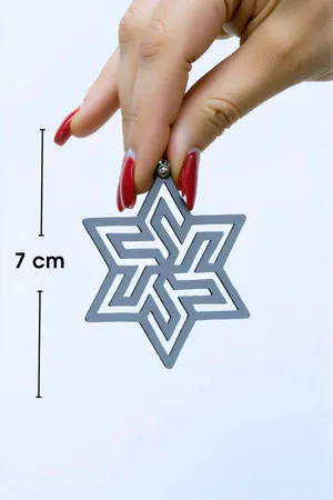 Black Abstract Star Earrings with Geometric Cut-Outs on a model, side profile