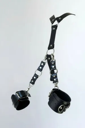 Black faux leather handcuff set with detachable O-ring chain and silver hardware