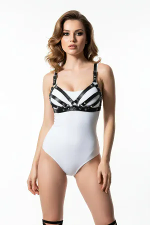Black faux leather strappy chest harness worn by a model, showing multiple horizontal bands