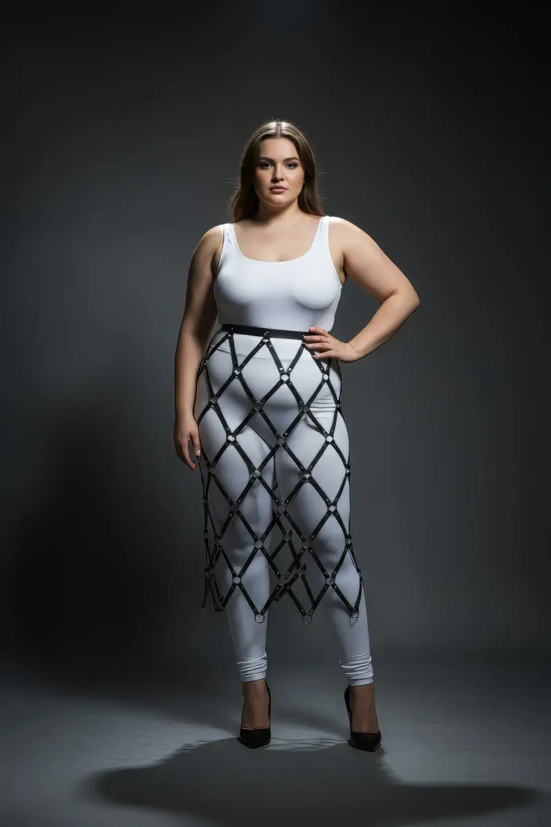 Side profile of the black diamond lattice skirt harness with o-rings draping over white leggings