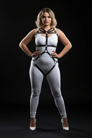 Black faux leather full body harness with O-ring details and adjustable straps on a plus-size model.