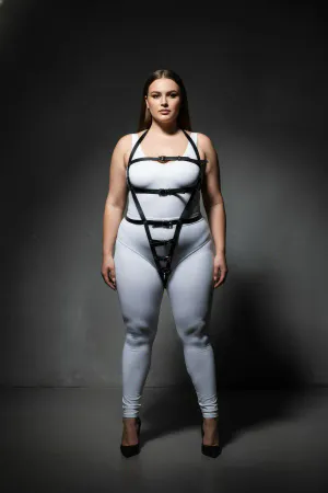 Black vegan leather full body harness with adjustable straps and V-strap design on a model.