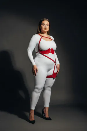 Red vegan leather strappy body harness with O-ring leg detail worn by a model