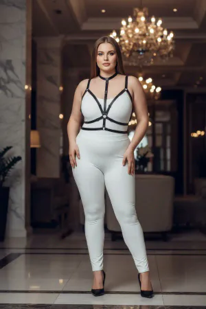 Black faux leather strappy body harness with central O-ring detail, worn by a plus-size model.