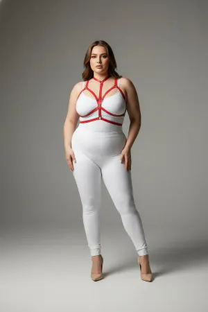 Red vegan leather body harness with adjustable straps and a central O-ring worn by a plus-size model