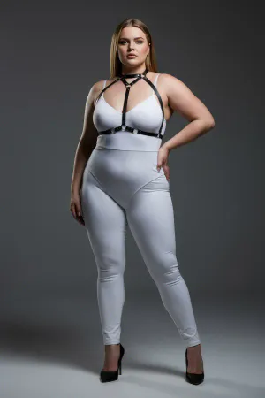 Black faux leather strappy body harness with silver O-rings and adjustable straps worn by a plus-size model.