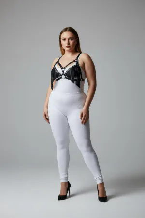 Black faux leather fringe body harness with central O-ring worn by a plus-size model.