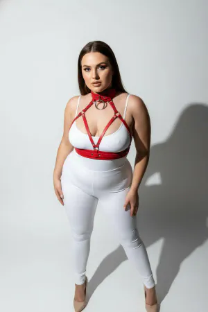 Red faux leather strappy body harness with matching choker and O-ring, worn by a plus-size model.