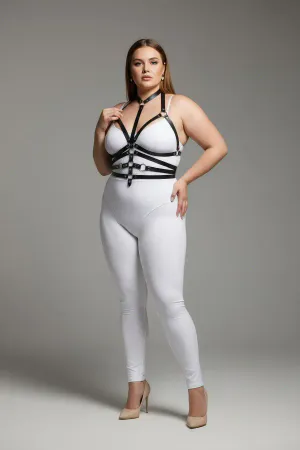 Black faux leather body harness with O-ring detail and adjustable straps worn by a plus-size model.