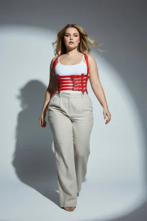 Red Faux Leather Multi-Strap Body Harness, worn over a white tank top with beige pants