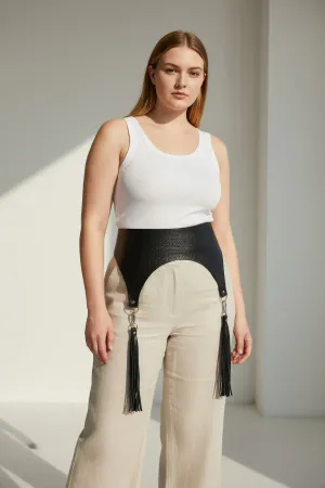 Black Faux Leather Waist Harness Belt with Tassels on a woman in a cafe